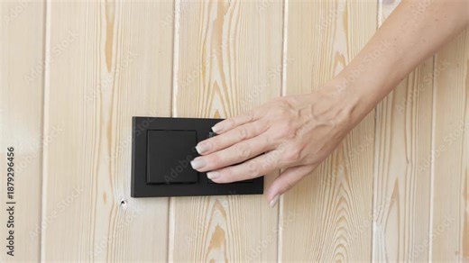 Daily routine at home female hand presses wall switch light control moment Simple action turning light on or off reflects modern lifestyle mindful pause light shaping comfort and energy awareness