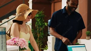 Tourists paying for room accommodation at resort, using credit card on pos terminal at front desk reception lobby. People on honeymoon vacation making payment upon their arrival. Handheld shot. Stock Video