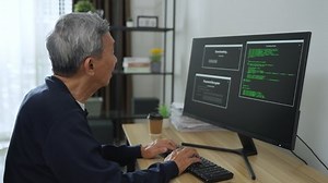 Senior asian man coding and programming on screen desktop. development web, hacker, developer concept.