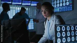 Female Scientist / Neurologist Working on a Personal Computer in Modern Laboratory. Medical Research Scientists Making New Discoveries. Shot on RED EPIC-W 8K Helium Cinema Camera.