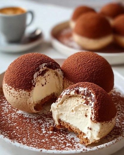 ☕ Cocoa-Dusted Tiramisu Domes 🍫 The secret’s in the (𝐂.𝐌.𝐍.𝐓) — 😉 ⬇ A chic, modern take on tiramisu—silky mascarpone domes with a soft coffee-soaked base and a velvety cocoa finish. Ingredients Mascarpone Cream: 1 cup mascarpone cheese 1 cup heavy cream, whipped 🥛 ⅓ cup powdered sugar .................... Recipe Details Prep Time: 25 minutes Chill Time: 2–3 hours Servings: 6 domes Difficulty: Medium Why You’ll Love It A modern, Instagram-worthy spin on the Italian classic. Light, creamy t