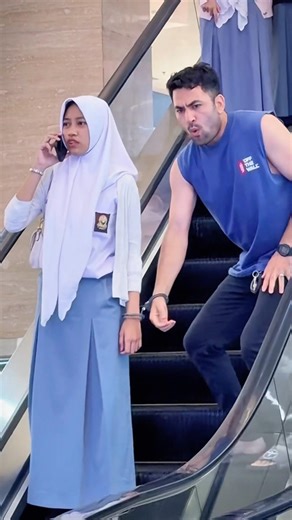 handcuffing girl joke on escalator