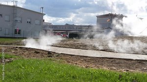 Steam escaping from the crash hot water pipes through the slits city sidewalk. Wide shot
