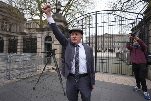 Michael Healy-Rae fist-pumps with protesters after resigning as government wins confidence motion on fuel protests