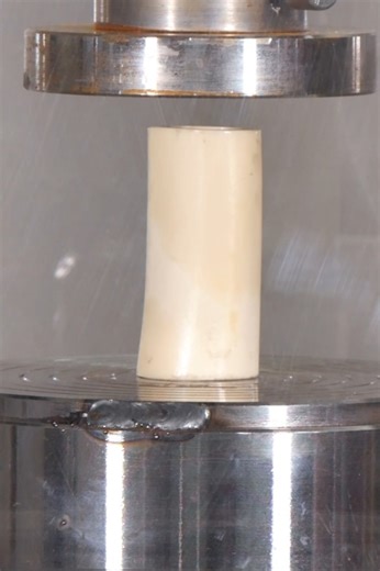 Hydraulic press testing cylindrical material strength