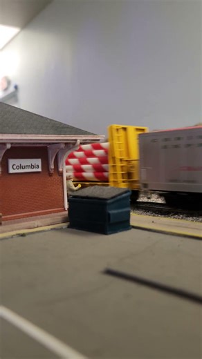 HO scale christmas freight train passing columbia station