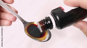 Liquid iron supplement curing anemia. Metal teaspoon syrup drops. Ferric glycinate oral medicine daily serving. Dietary nutrition ferrum mineral close up video
