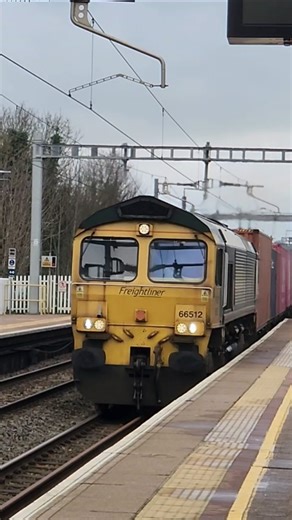 Freightliner Class 66 pulls a intermodal train through Pangbourne Train Station