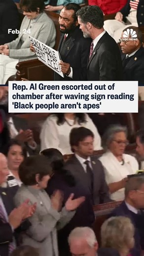 Rep. Al Green is escorted out of President Donald Trump's State of the Union address after waving a sign that says "Black people aren't apes," an apparent reference to a video Trump posted that depicted former President Barack Obama and former first lady Michelle Obama as apes. | NBC News