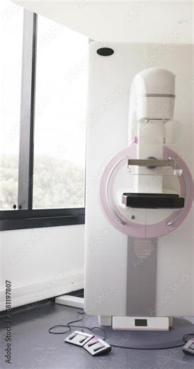 Vertical video: Camera is sliding and centering mammography unit near window to tighten framing