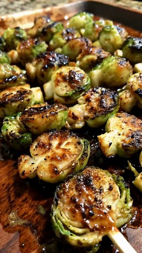 Brussels sprouts halved and skewered. Brushed with maple syrup, Dijon mustard, and garlic. Roast at 400°F for 20 minutes until golden, caramelized, and tender with a sweet-savory glaze that shines. ➤ Ingredients 1 lb (450 g) Brussels sprouts, trimmed and halved 2 tbsp olive oil Salt and black pepper, to taste 2 tbsp maple syrup 1 tbsp Dijon mustard 1 tsp apple cider vinegar 1/2 tsp garlic powder Wooden or metal skewers ➤ Instructions Preheat oven to 400°F (200°C) or heat a grill to medium-high. 