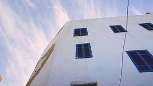 White Building with Blue Windows | Free Stock Video Footage