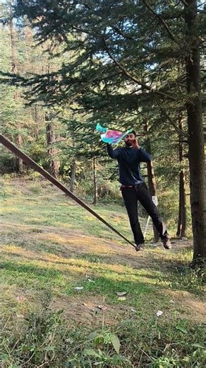 Man Juggles Spinning Cloth While Walking on Slack Line - 1454742