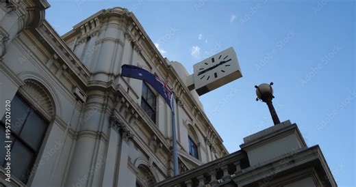 Historic Brunswick Town Hall on Sydney Road in suburban Melbourne, Australia, with an Australian flag displayed at the front. Victorian-era civic design and local heritage significance.