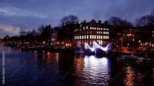 Amsterdam in the Netherlands by night at the river Amstel