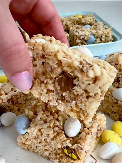 Easter Rice Krispie Treats are a fun springtime twist on the classic treat! Ooey-gooey marshmallow, crispy rice cereal, and chocolate eggs make this a sweet and easy dessert for all of your spring celebrations – the kids love them! #recipe #nobake #ricekrispietreats #cadburyeggs #easter
