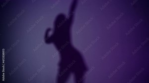 Woman moving in front of the wall lit with purple light. Shadow dancing beautifully.