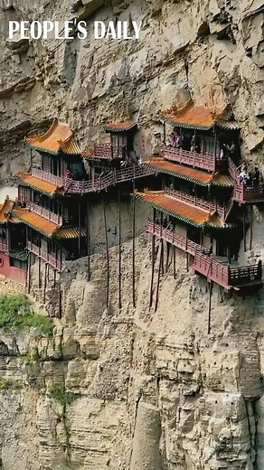 The 1,500-year-old hanging temple, also known as "Mid-Air Temple," is known for its miraculous perch on the mountain in north China's Shanxi Province. | People's Daily, China
