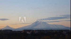 Stunning sunrise time lapse showcasing pink and yellow clouds over Mount Ararat partially covered in snow, with city buildings in the foreground, uhd, 4k, 3840, 2160
