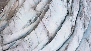 Flying over glacier in Alps. Top Down shot.