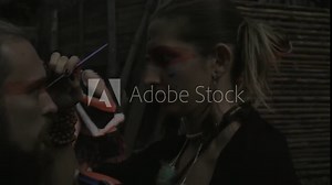 ethno group, they dancing and playing drums and doing makeup