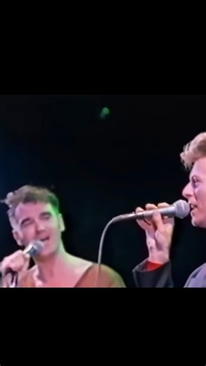 The Smiths on Instagram: "David Bowie joins Morrissey to cover T. Rex’s “Cosmic Dancer” live at the Inglewood Forum, Los Angeles, 1991. From Morrissey’s Autobiography: "At The Forum in Los Angeles a royal David Bowie walks onstage to join me for the encore; he is stately against my last-gasp exhaustion. The 12-year-old within me - unable to leave for school unless I'd soothed my sickness with at least one spin of Starman - bathes in the moment with disbelief". #morrissey #davidbowie #trex #marcb