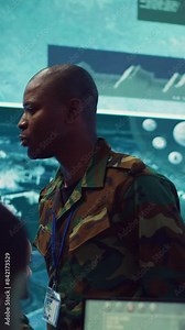 Vertical Video Lieutenant general coordinating his army troops for a complex military operations, ensuring every unit is synchronized and informed about a new national safety mission. Command center Stock Video