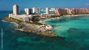 Aerial view of Cancun and lighthouse from a height. Cape of Mexico. Punta Cancun lighthouse and the Hyatt Ziva Cancunt Hotel. View from above of the waterfront and the hotel area of ​​Cancun.