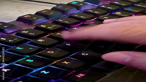 close up of a hand pressing the keys of a gaming computer keyboard, with backlit black keys changing color,human hand tapping a keyboard, RGB light, 4k, vertical