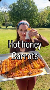 Fall hot honey carrots 🍁🥕 Line a baking pan with parchment paper Start with one package of rainbow carrots. Peel and cut the ends off. Cut them in half. Spead 1 & 1/2 cups shredded parmesan cheese across baking pan. Layer carrots (flat side down) across Parmesan. Brush carrots with olive oil. Sprinkle the following spices on carrots: Paprika (1 tbsp total) Garlic powder (1 tbsp total) Red pepper flakes to taste Salt to taste Pepper to taste Top with more parmesean cheese - I did over a cup Bak