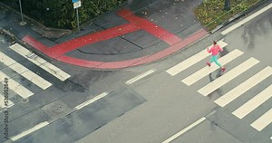Running woman, girl running on a rainy autumn day. Female runner in street, crosswalk, fitness training outdoors. Run, Sport concept.