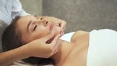 Charming and calm woman on relaxing procedure in spa. Female spending...