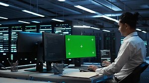 clip-3562876961-system-administrator-overseeing-data-center-using-green