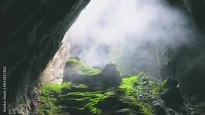 Drone footage flying backward shot tiny people in Hang Son Doong, Vietnam