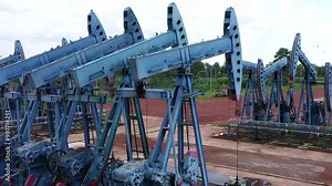 Working Pumpjack industrial oil pump jack working and pumping crude oil for fossil fuel energy at oil and gas a land rig onshore drilling rig