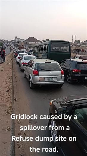 Gridlock caused by a spillover from aRefuse dump site on the road.