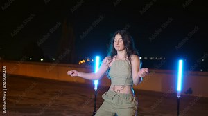 Sensual young dancer dancing trap modern music int the street at night