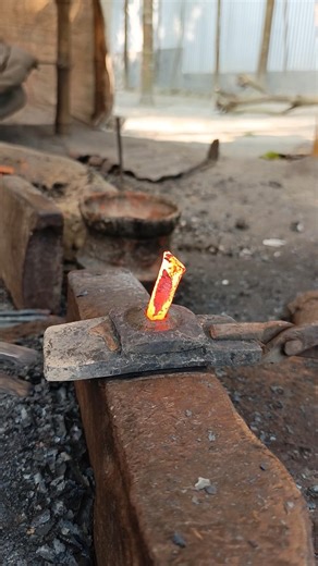 Watch how a skilled blacksmith hand-forges nails from old iron by hammering it into shape."