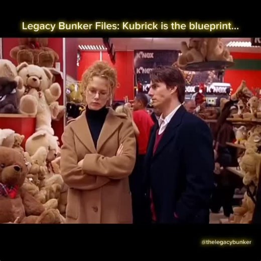 The Legacy Bunker ™️ on Instagram: "Eyes Wide Shut is often discussed for the masked party, but Kubrick’s most unsettling move is what happens after. Bill stumbles into a private, invitation only world, gets recognized as someone who does not belong, and the message is clear: stop asking questions and go back to your life. Then comes the toy store. Two men seen earlier at Ziegler’s party appear again in the background, quietly browsing near Bill and Alice. Helena drifts toward them, checks back
