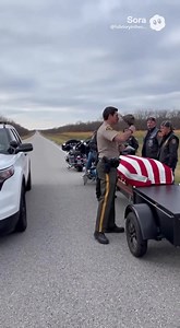 COP PULLS OVER GROUP OF BIKERS—WHAT THEY WERE ESCORTING MADE HIM SALUTE He was ready for a confrontation. Hand on his holster, face stone-cold. Twelve bikers, engines rumbling, riding in a tight formation down the highway shoulder. No hazard lights. No permit. Just leather jackets and solemn faces. He lit up his siren and pulled in front of them, forcing the lead rider to stop. “You can’t just take over the road like that,” he snapped. “This isn’t a parade.” The man at the front—silver beard, ey