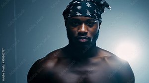 A muscular athlete performs an intense workout routine, showcasing strength training techniques in a well-lit gym environment.