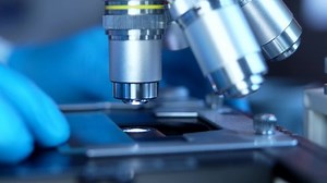 Cinematic Close Up Of Scientist Preparing A Microscope For Research