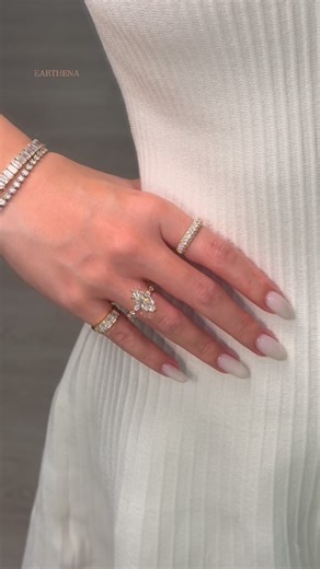 EARTHENA on Instagram: "Golden hour hits different when you’re wearing the Grace marquise ring. 🤍✨ Rings featured 🤍The Grace, 3.04ct Elongated Marquise-Cut Diamond Hidden Eternity Halo Engagement Ring 🤍The Remi, Pavé Dome Diamond Band 🤍The Rae, 5-Stone Radiant-Cut Diamond Pinky Ring luxury lifestyle jewelry // diamond engagement ring // marquise cut diamond ring // hidden halo engagement ring // pavé diamond band // pinky ring diamonds // everyday fine jewelry // modern bridal jewelry // Bev