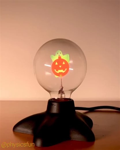 physicsfun on Instagram: "Halloween Neon Glow Bulb: the pumpkins, with a high voltage between them, glow orange with light from the emission spectrum of the excited neon atoms of the low pressure gas within the bulb. The ghost glows from a coating of phosphor which is stimulated to emit green light by ultraviolet (and invisible) photons. Excited neon atoms emit photons both in the visible (mostly orange and yellow wavelengths), and also in the UV wavelengths, and these ultraviolet photons are ab
