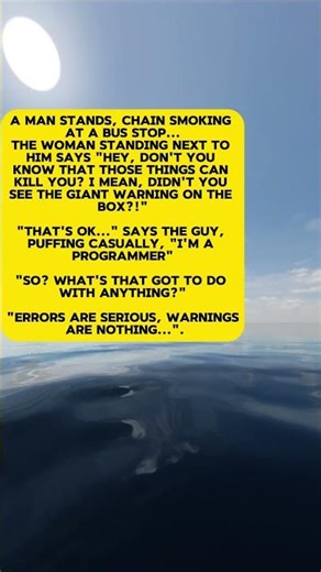 A man stands, chain smoking at a bus stop...