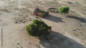 Aerial view of an African village of huts in the savannah. rural village with mud houses in the African desert seen from a drone. exotic journey and adventure with aerial footage. Traditional houses