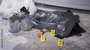 Examining forensic evidence and putting it in plastic bags.