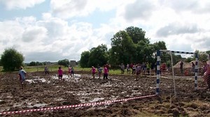 Swamp football championship in Belarus. Girls playing soccer in the mud. Belarus/Oshmyany/1 August 2020