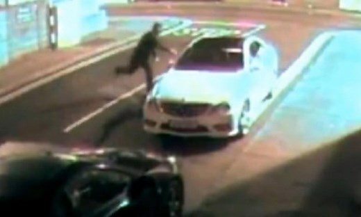 CCTV: man throws brick at car window, knocks himself out - video
