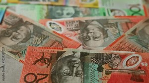 Australian banknotes scattered featuring various denominations and vibrant colors, depicting iconic figures and designs, perfect for finance, investment, wealth, and currency themes. Stock Video